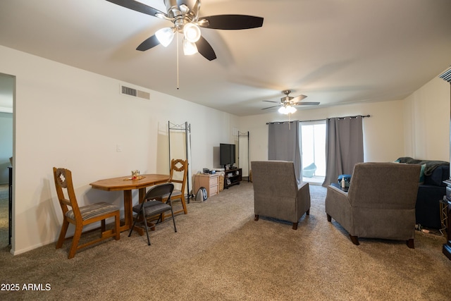 living room with visible vents, light colored carpet, and ceiling fan