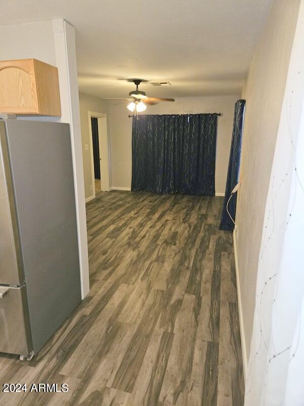 interior space with ceiling fan and dark hardwood / wood-style floors