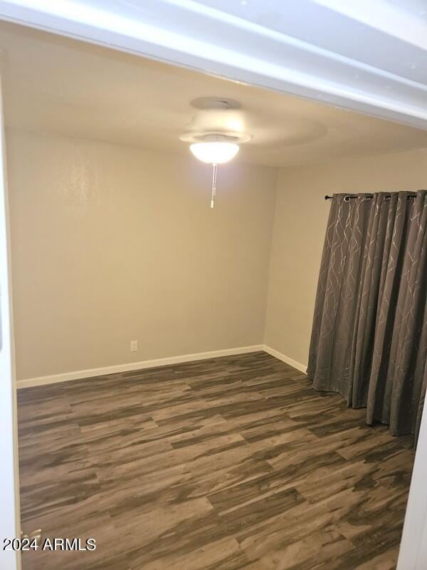 spare room with dark hardwood / wood-style floors