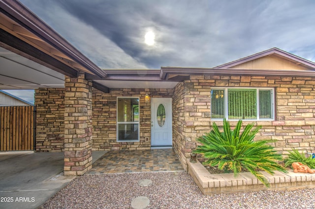 property entrance featuring stone siding
