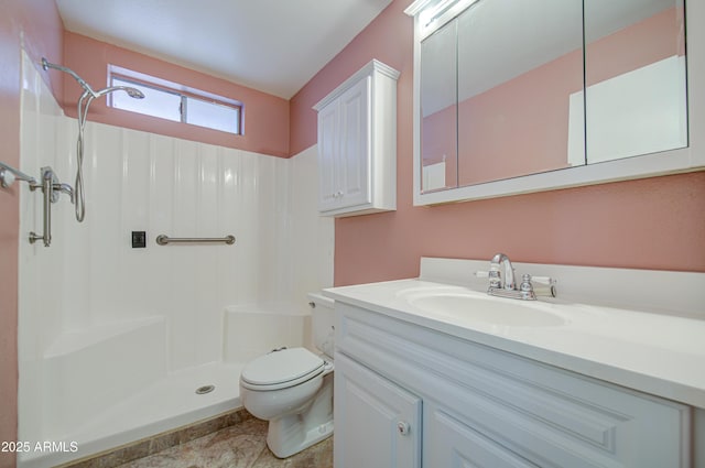 bathroom featuring vanity, walk in shower, and toilet
