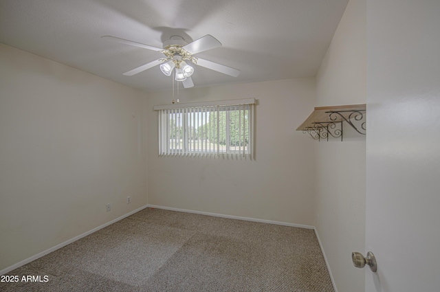 carpeted spare room with baseboards and a ceiling fan