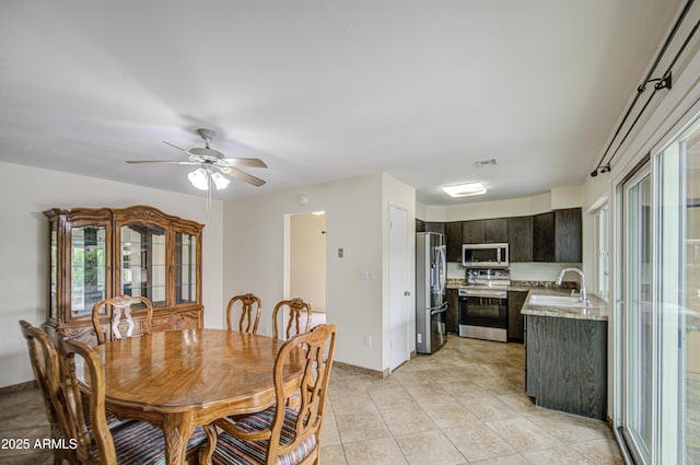 dining area with a ceiling fan, baseboards, visible vents, and light tile patterned floors