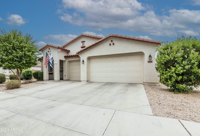 mediterranean / spanish home with a garage