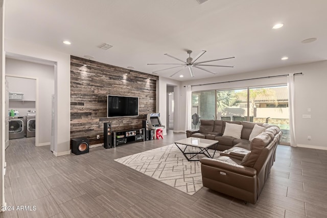 living room with independent washer and dryer and ceiling fan