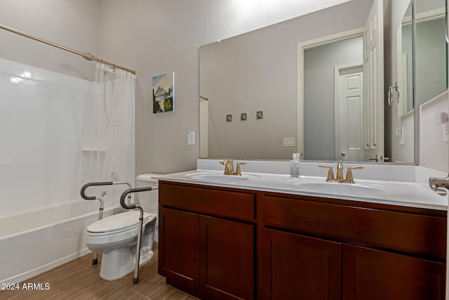 full bathroom featuring hardwood / wood-style floors, vanity, shower / bath combination with curtain, and toilet