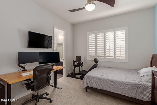 bedroom featuring connected bathroom, ceiling fan, and light colored carpet