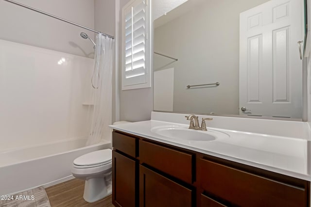 full bathroom featuring shower / tub combo with curtain, vanity, hardwood / wood-style floors, and toilet