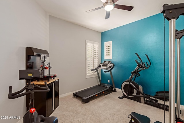 workout room featuring ceiling fan and carpet floors