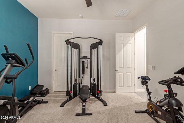 exercise room featuring ceiling fan and light colored carpet