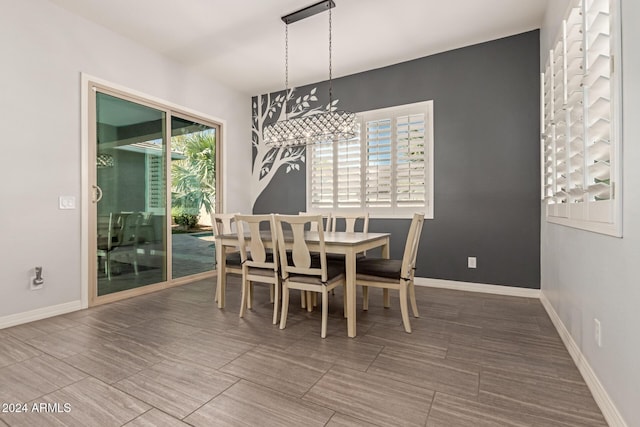 dining space with a wealth of natural light and an inviting chandelier