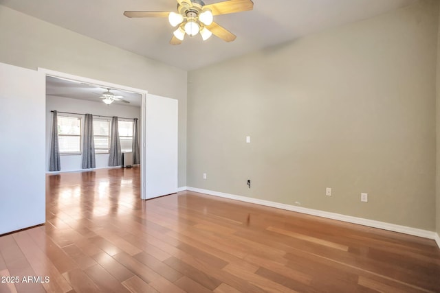 spare room with hardwood / wood-style floors and ceiling fan