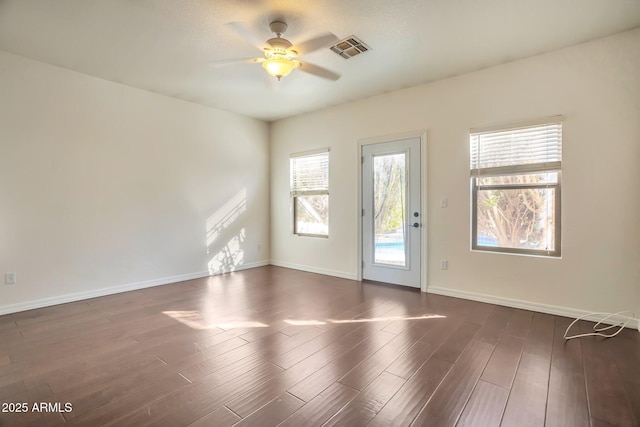 spare room with dark wood-type flooring and ceiling fan