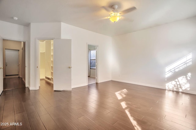 spare room with ceiling fan and dark hardwood / wood-style flooring