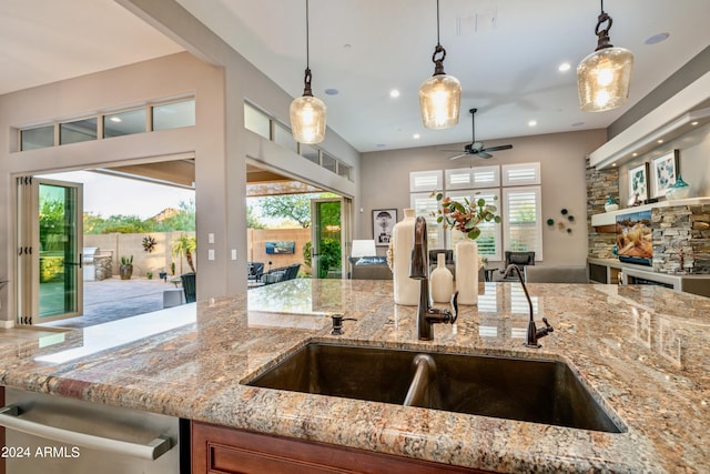 kitchen with light stone countertops and hanging light fixtures