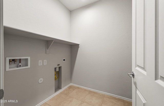 clothes washing area featuring hookup for a gas dryer, laundry area, washer hookup, baseboards, and electric dryer hookup