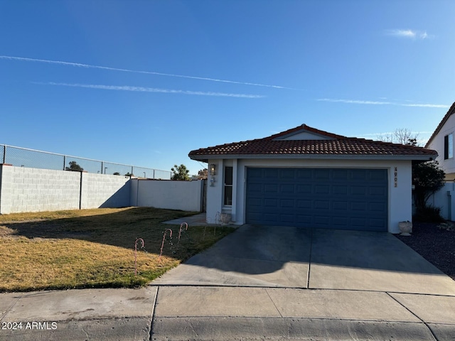 view of front of house with a front yard and a garage