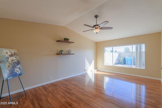 unfurnished room with ceiling fan, lofted ceiling, and hardwood / wood-style flooring