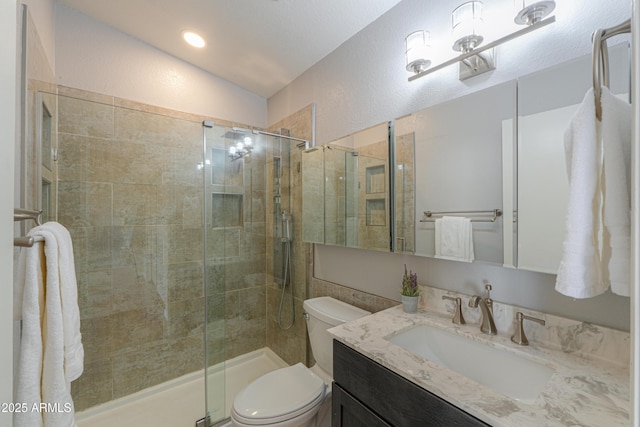 bathroom with lofted ceiling, vanity, an enclosed shower, and toilet