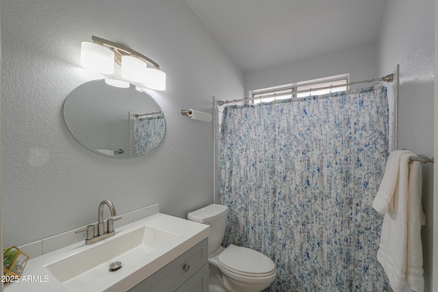 bathroom featuring walk in shower, vanity, and toilet