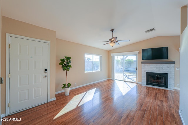 unfurnished living room featuring a fireplace, hardwood / wood-style flooring, ceiling fan, and lofted ceiling