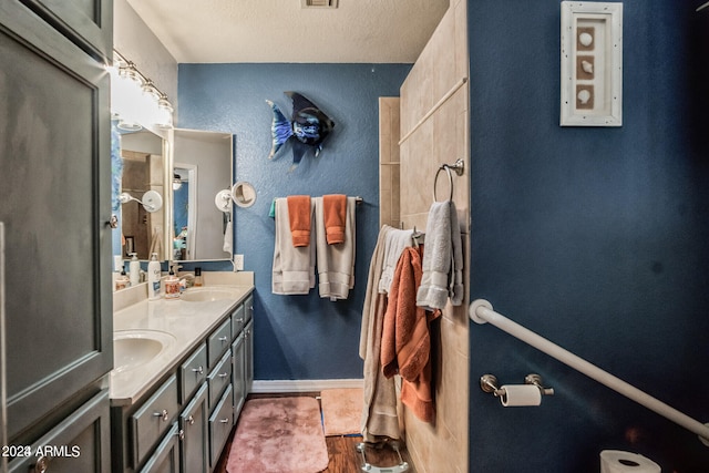 bathroom featuring vanity, a textured ceiling, and hardwood / wood-style flooring