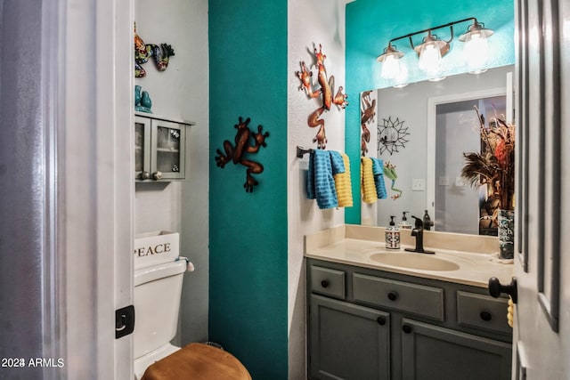 bathroom featuring vanity and toilet