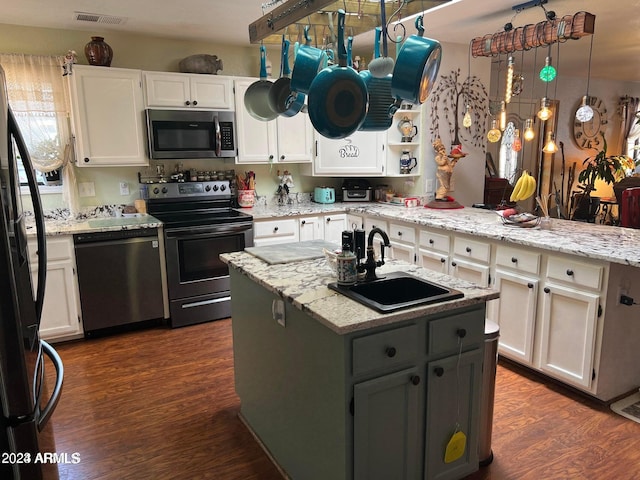 kitchen with white cabinetry, stainless steel appliances, sink, and dark hardwood / wood-style flooring