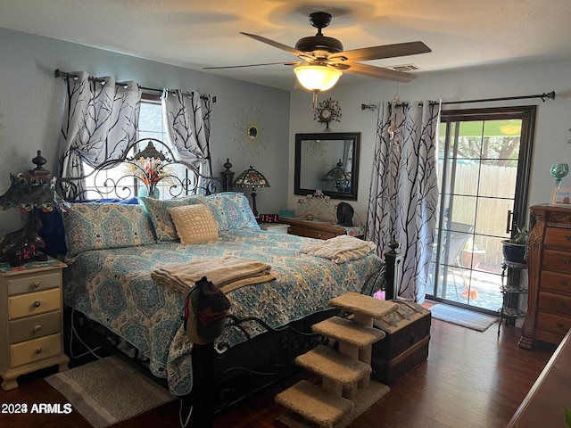 bedroom with access to outside, multiple windows, dark hardwood / wood-style floors, and ceiling fan