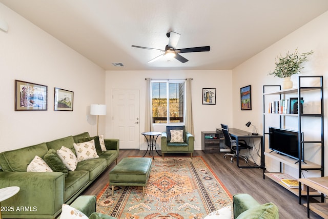 living room featuring wood-type flooring and ceiling fan