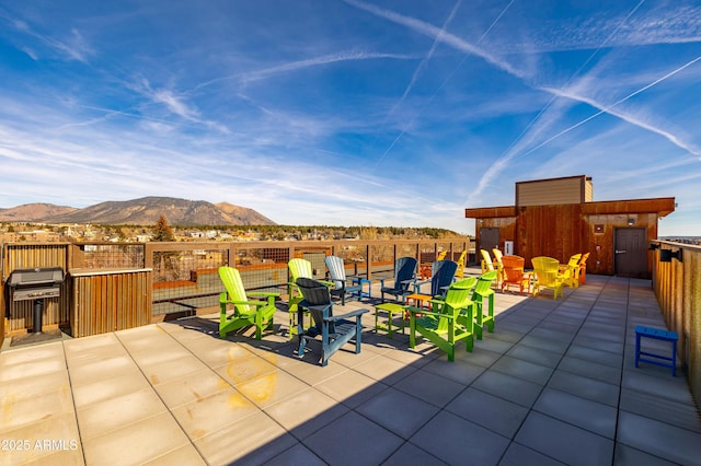 view of patio / terrace featuring a mountain view and a grill