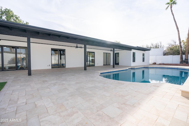 view of pool with a patio and ceiling fan