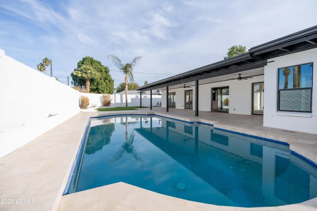 view of swimming pool with ceiling fan and a patio area