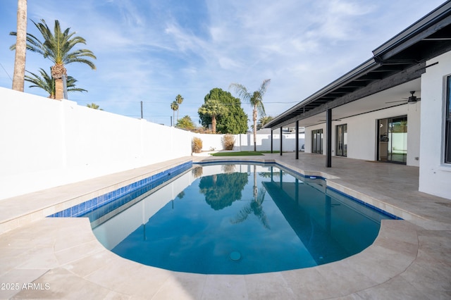 view of swimming pool with ceiling fan and a patio area