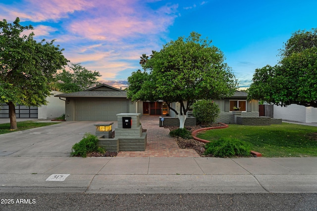 315 E Marlette Ave, Phoenix, AZ 85012 - view of front of house featuring a garage, a yard, and driveway
