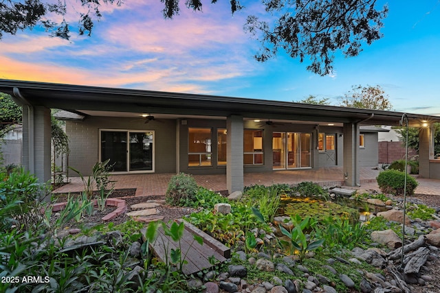 315 E Marlette Ave, Phoenix, AZ 85012 - back of property at dusk with a ceiling fan and a patio area