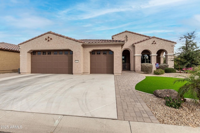 mediterranean / spanish-style house with a garage