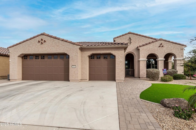 mediterranean / spanish home with a garage