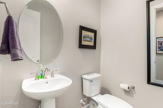 bathroom with toilet and sink