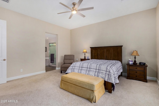 bedroom with light colored carpet, ceiling fan, and connected bathroom