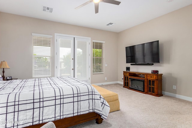 carpeted bedroom with ceiling fan and access to exterior