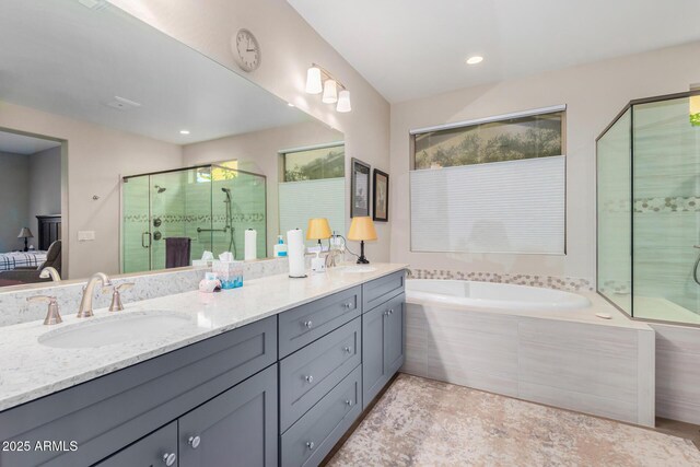 bathroom featuring independent shower and bath and vanity