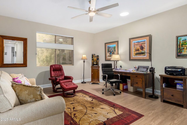 home office with ceiling fan and light hardwood / wood-style flooring