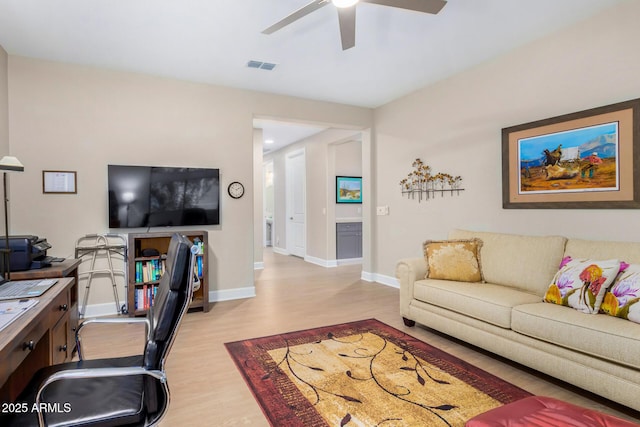 living room featuring ceiling fan and light hardwood / wood-style flooring