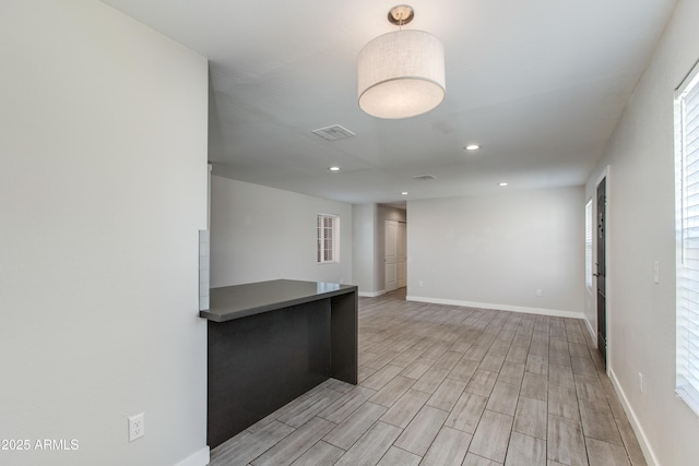 spare room featuring recessed lighting, visible vents, baseboards, and light wood-style flooring