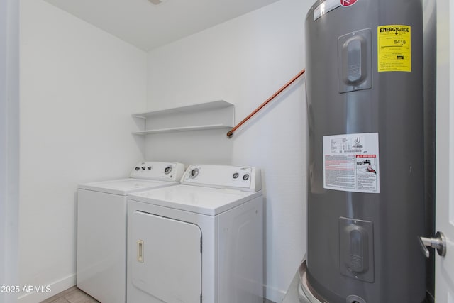 clothes washing area with laundry area, electric water heater, baseboards, and separate washer and dryer