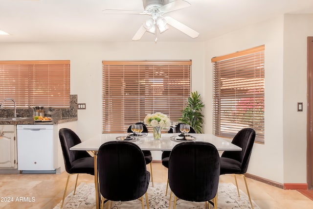 dining room featuring ceiling fan, sink, and light tile patterned floors