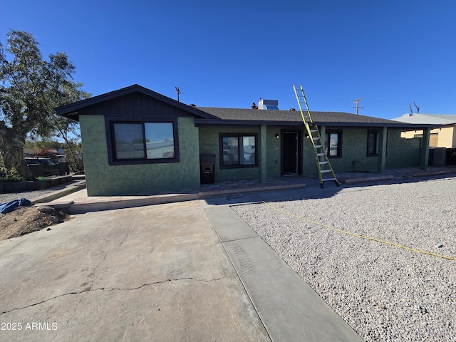 ranch-style home with board and batten siding and stucco siding