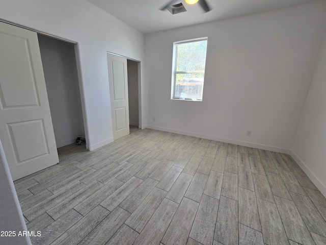 unfurnished bedroom with baseboards and light wood-style floors