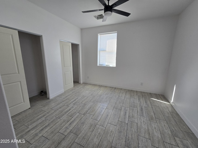 unfurnished bedroom with a ceiling fan, wood finish floors, and baseboards